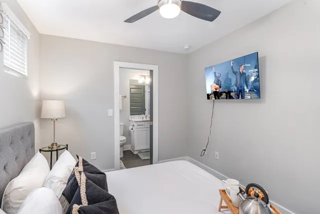 a bedroom with a bed and a chandelier
