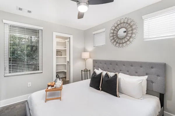 a bedroom with a large bed and a window