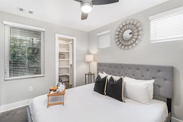 a bedroom with a large bed and a window