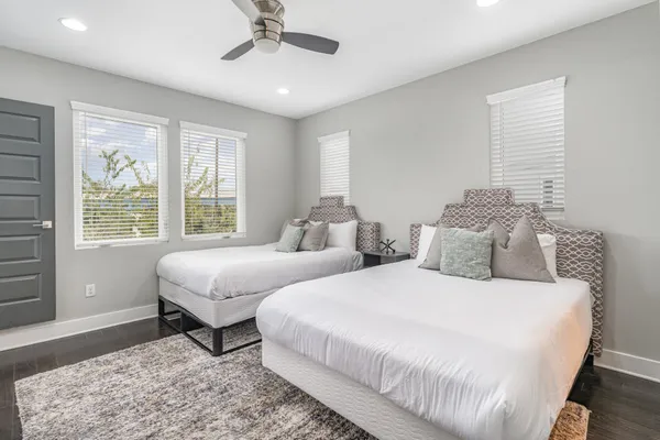 a bedroom with two beds and a window