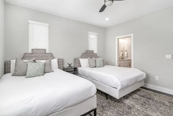 a bedroom with two beds and painting on the wall