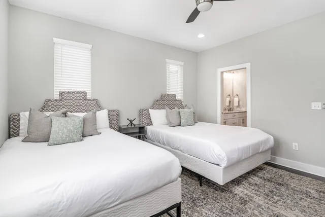 a bedroom with two beds and painting on the wall