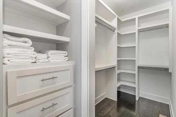 a view of walk in closet with empty racks