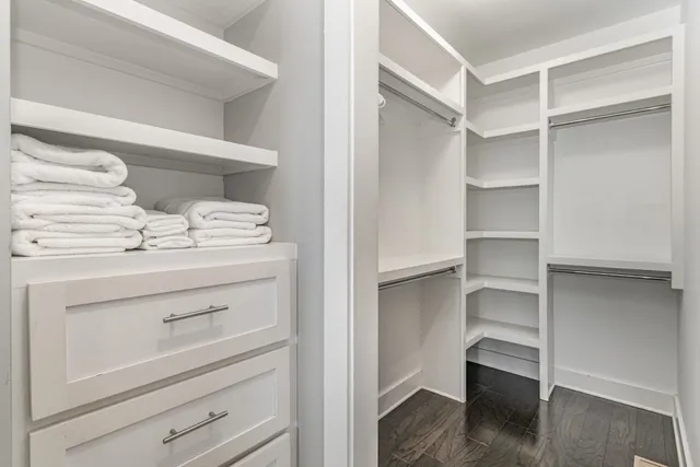 a view of walk in closet with empty racks