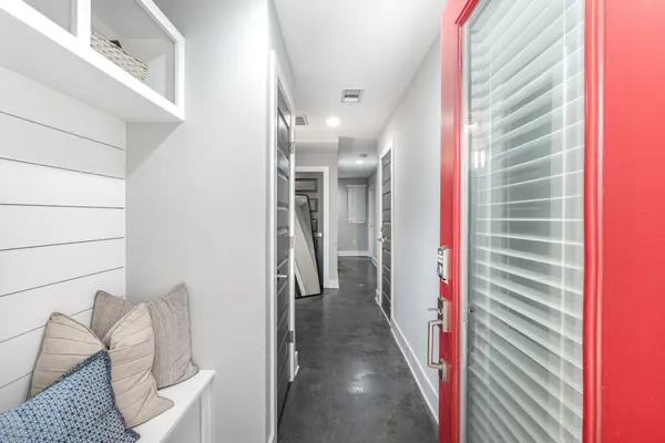 a view of a hallway and a livingroom with furniture