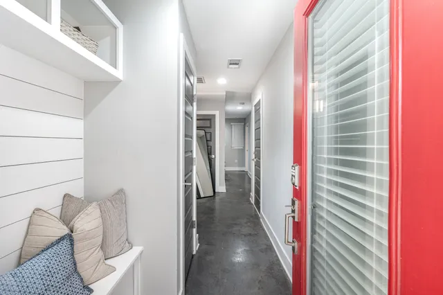 a view of a hallway and a livingroom with furniture