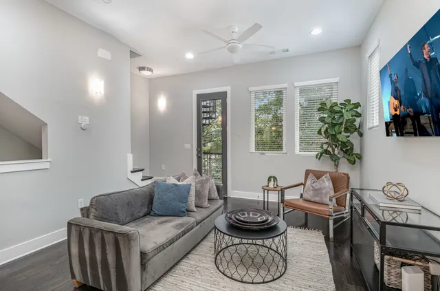 a living room with furniture and a potted plant
