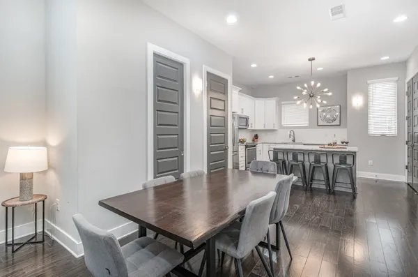 a view of a dining room with furniture and wooden floor