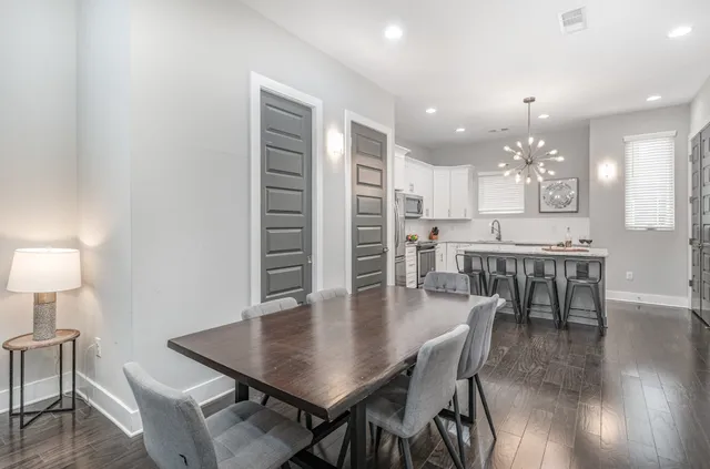 a view of a dining room with furniture and wooden floor