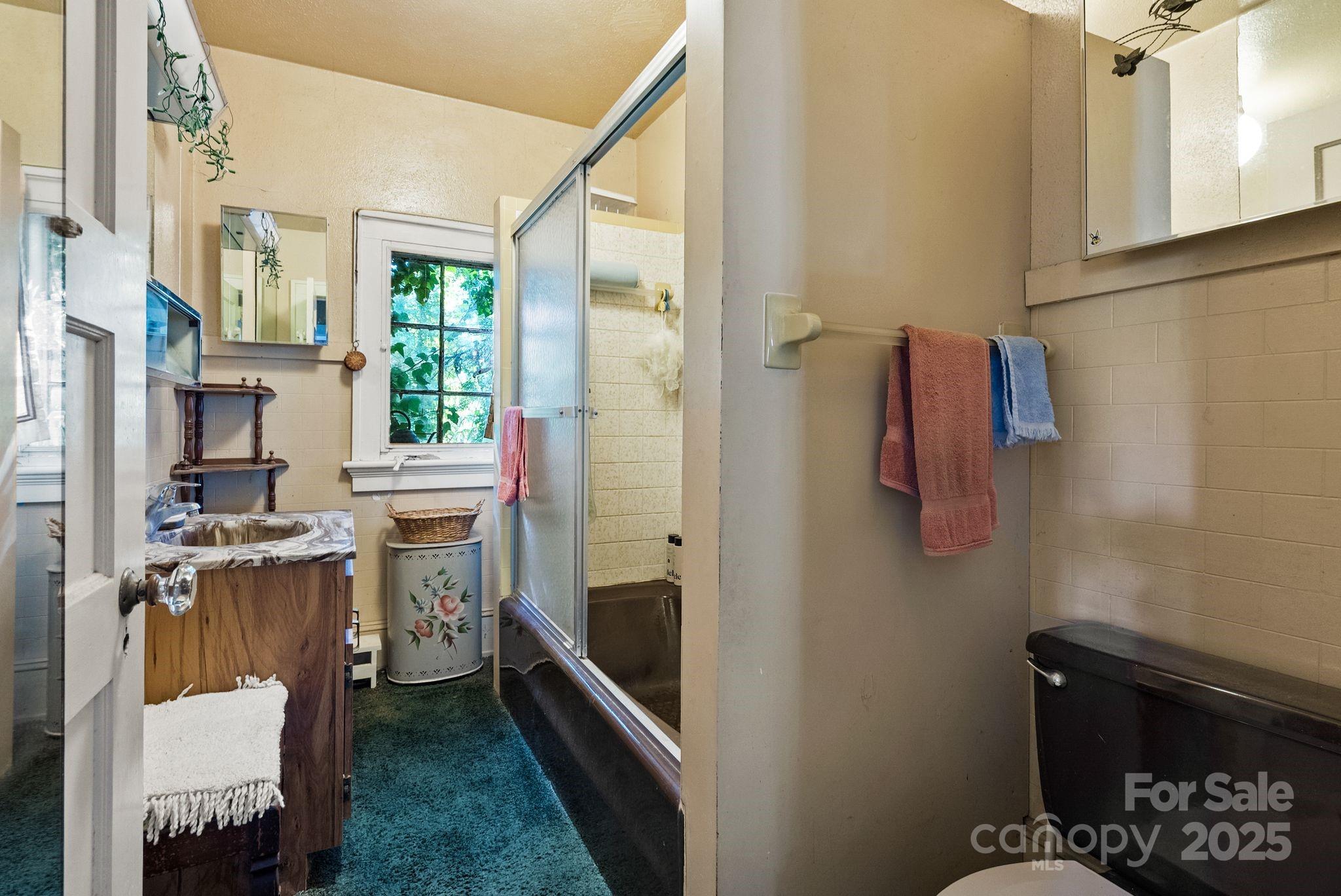 414 Beaucatcher Road Asheville, NC 28805 - Photo 17 of 34 a bathroom with a sink toilet and shower
