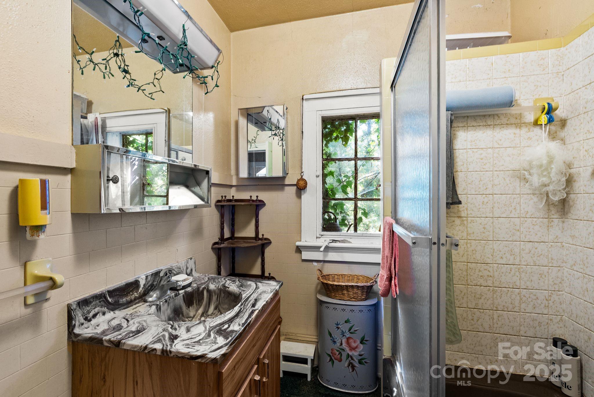 414 Beaucatcher Road Asheville, NC 28805 - Photo 18 of 34 a kitchen with sink refrigerator and window