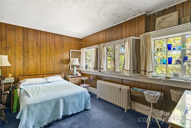 a bed room with a bed and a dresser