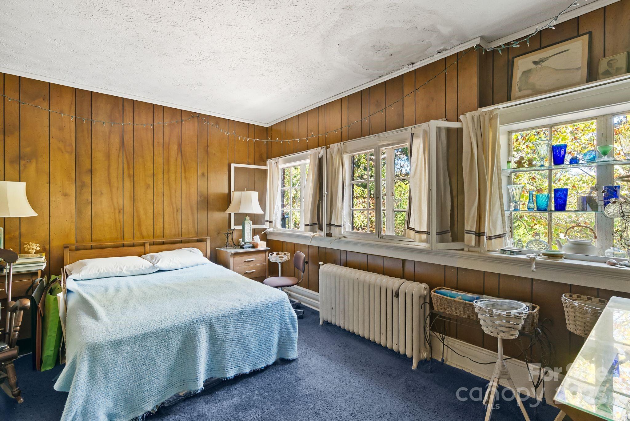 414 Beaucatcher Road Asheville, NC 28805 - Photo 20 of 34 a bedroom with a bed and a table