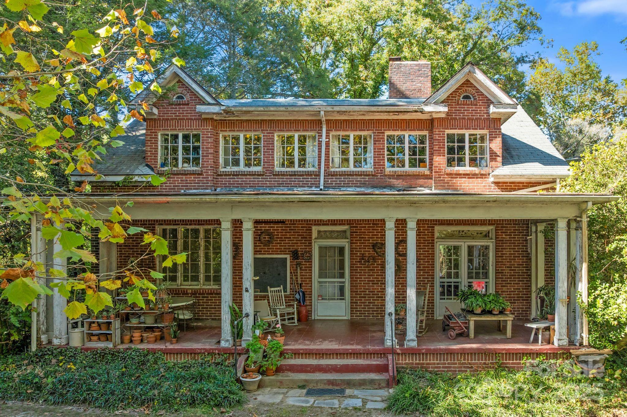 414 Beaucatcher Road Asheville, NC 28805 - Photo 2 of 34 front view of a brick house with a large windows