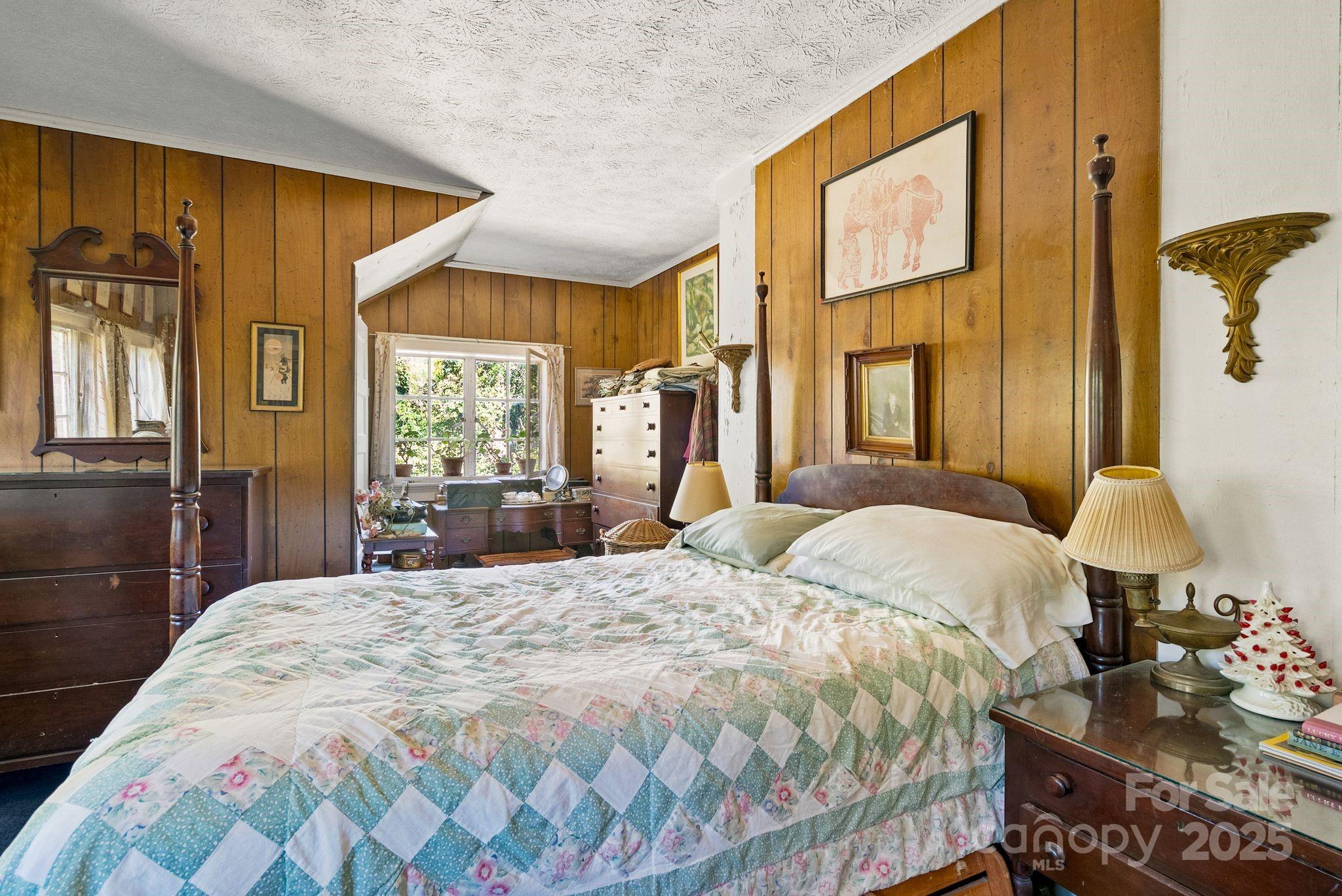 414 Beaucatcher Road Asheville, NC 28805 - Photo 22 of 34 a bedroom with a bed and a large window