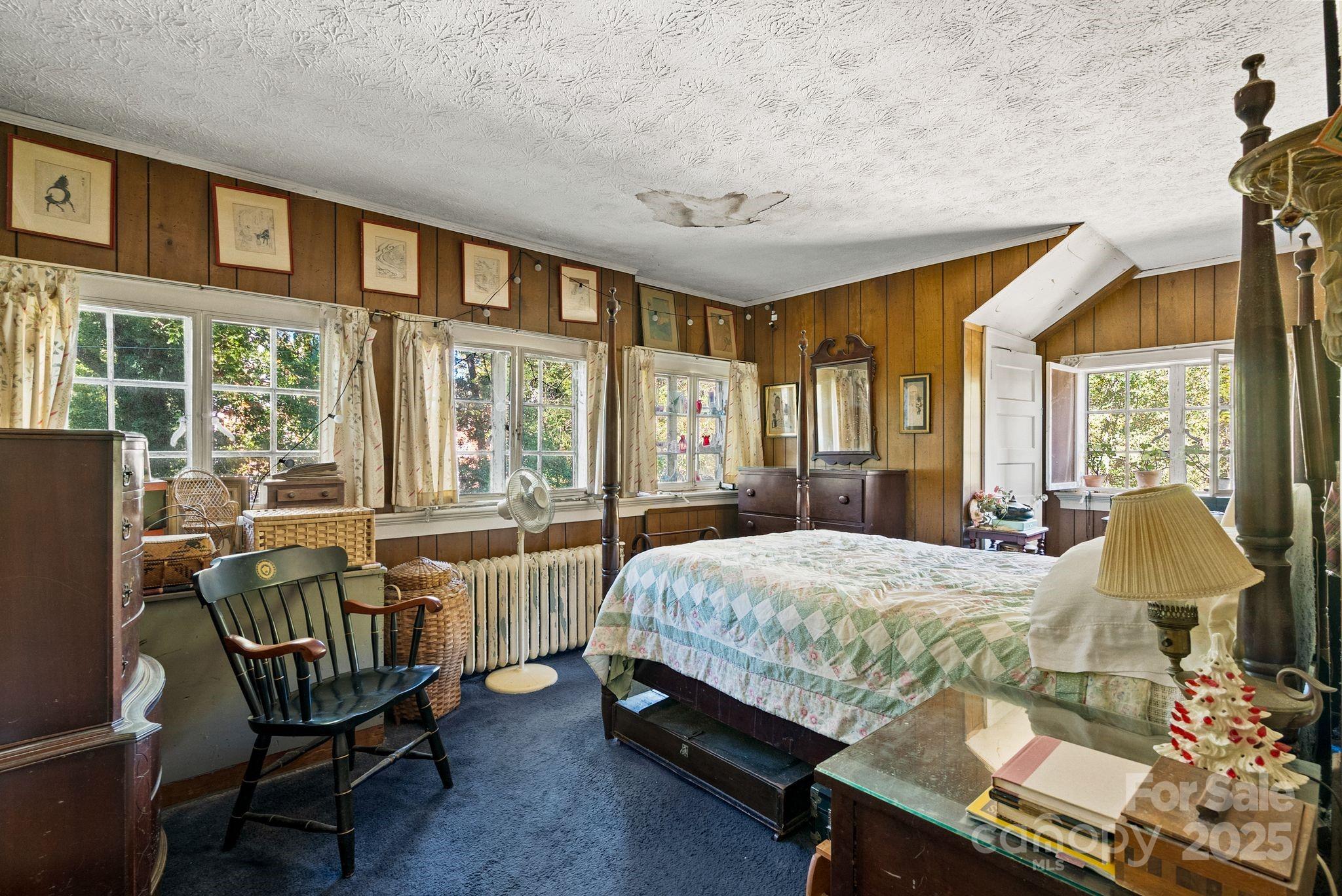 414 Beaucatcher Road Asheville, NC 28805 - Photo 23 of 34 a bedroom with a bed chair and window