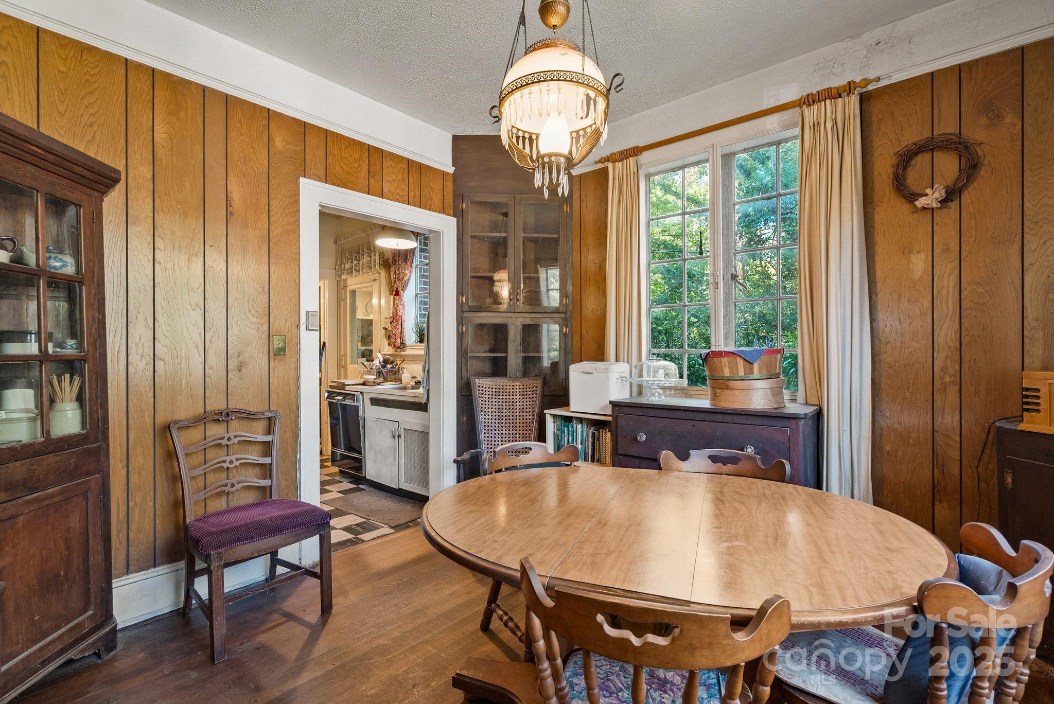 414 Beaucatcher Road Asheville, NC 28805 - Photo 10 of 34 a view of a dining room with furniture window and wooden floor