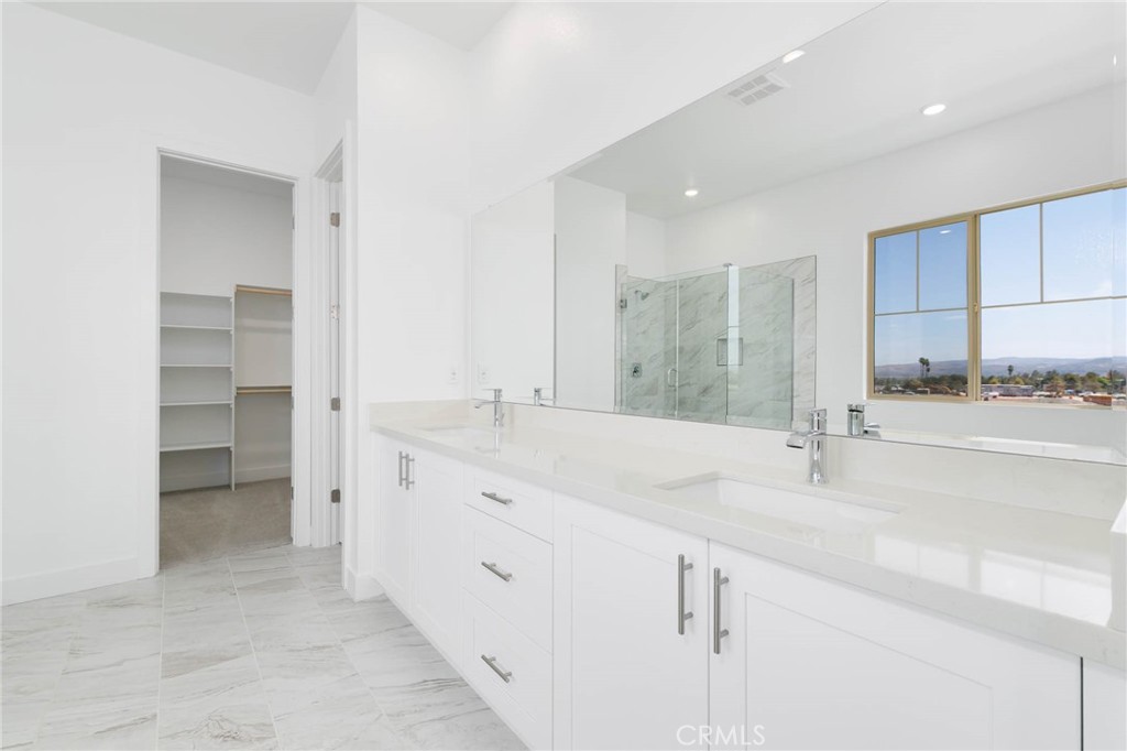 208 Lily Loop Irvine, CA 92618 - Photo 12 of 23 a bathroom with a granite countertop sink and a mirror