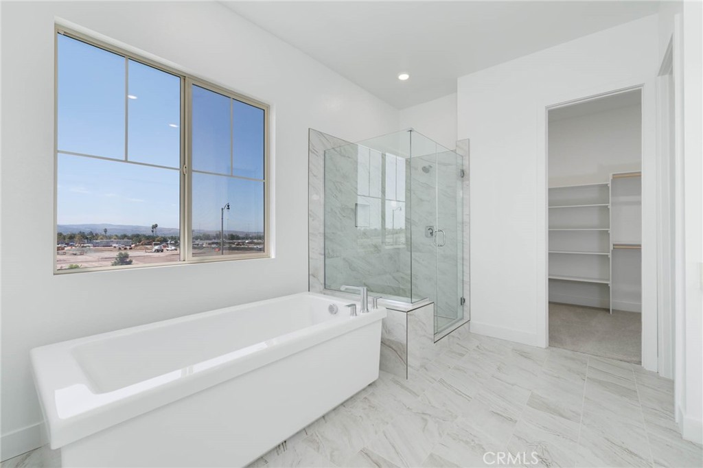 208 Lily Loop Irvine, CA 92618 - Photo 13 of 23 a bathroom with a bathtub and a shower