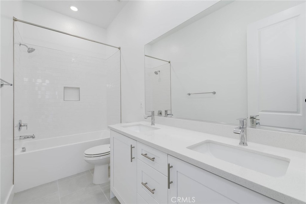 208 Lily Loop Irvine, CA 92618 - Photo 20 of 23 a bathroom with a sink toilet double vanity and shower
