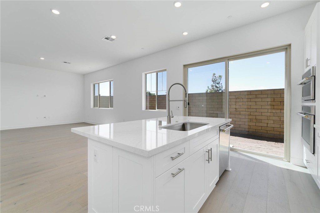 208 Lily Loop Irvine, CA 92618 - Photo 4 of 23 a kitchen with sink and mirror
