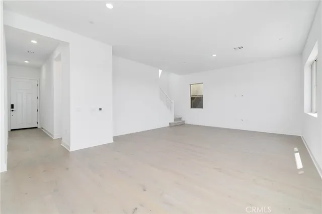 an empty room with closet and windows