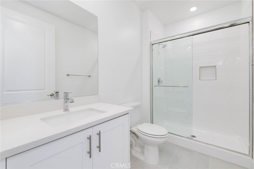 208 Lily Loop Irvine, CA 92618 - Photo 9 of 23 a bathroom with a sink a toilet and shower