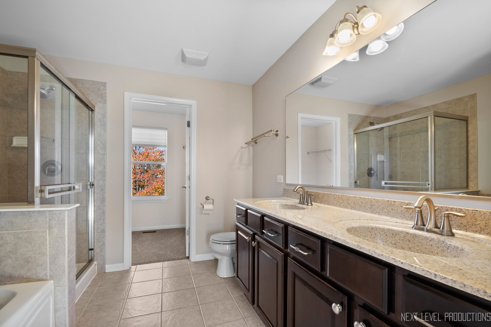 2842 Church Road Aurora, IL 60502 - Photo 15 of 28 a bathroom with a granite countertop sink a large mirror and a shower