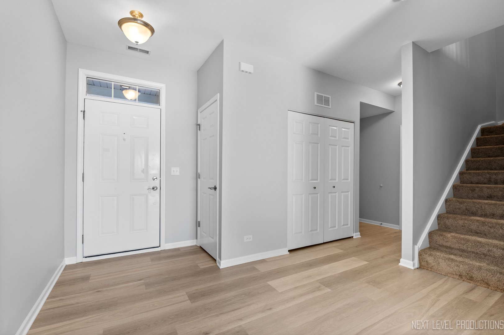2842 Church Road Aurora, IL 60502 - Photo 3 of 28 a view of an empty room with wooden floor and stairs