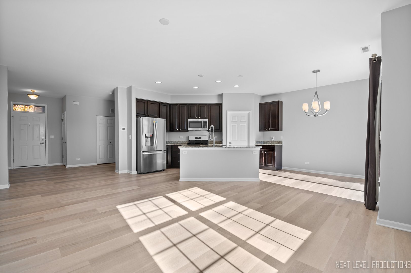 2842 Church Road Aurora, IL 60502 - Photo 6 of 28 a view of kitchen with stainless steel appliances kitchen island empty cabinets and wooden floor