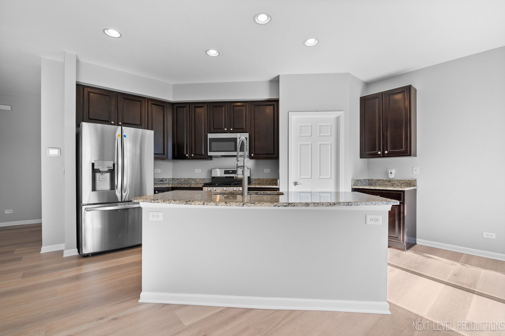 2842 Church Road Aurora, IL 60502 - Photo 7 of 28 a kitchen with stainless steel appliances granite countertop a refrigerator a stove a sink a microwave and wooden floor