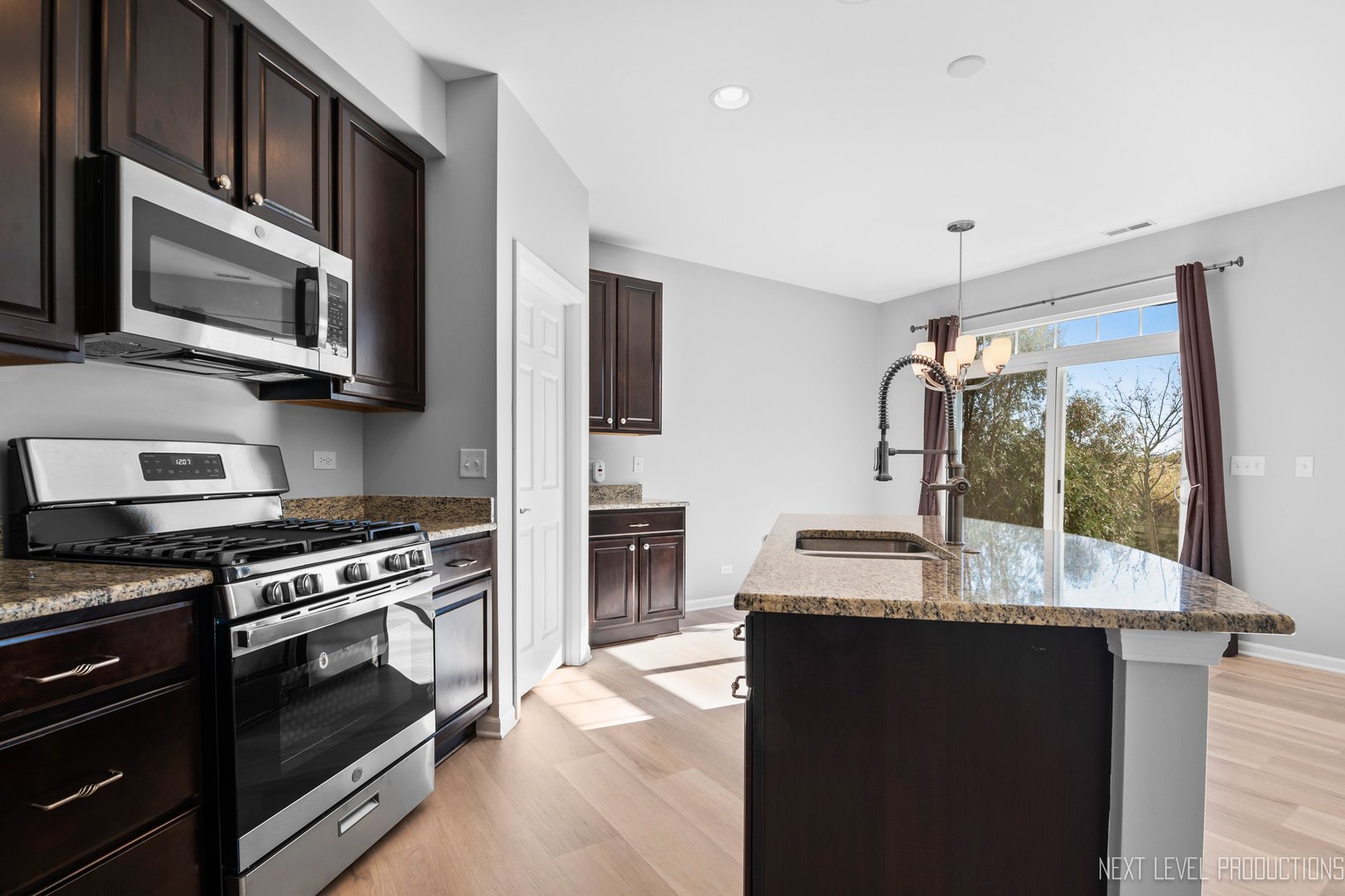 2842 Church Road Aurora, IL 60502 - Photo 8 of 28 a kitchen with stainless steel appliances granite countertop a stove microwave and sink