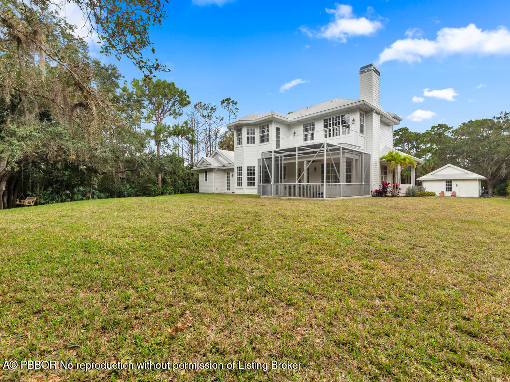 1001 Southeast Ranch Road Northeast Jupiter, FL 33478 - Photo 23 of 32 a view of a house with a yard