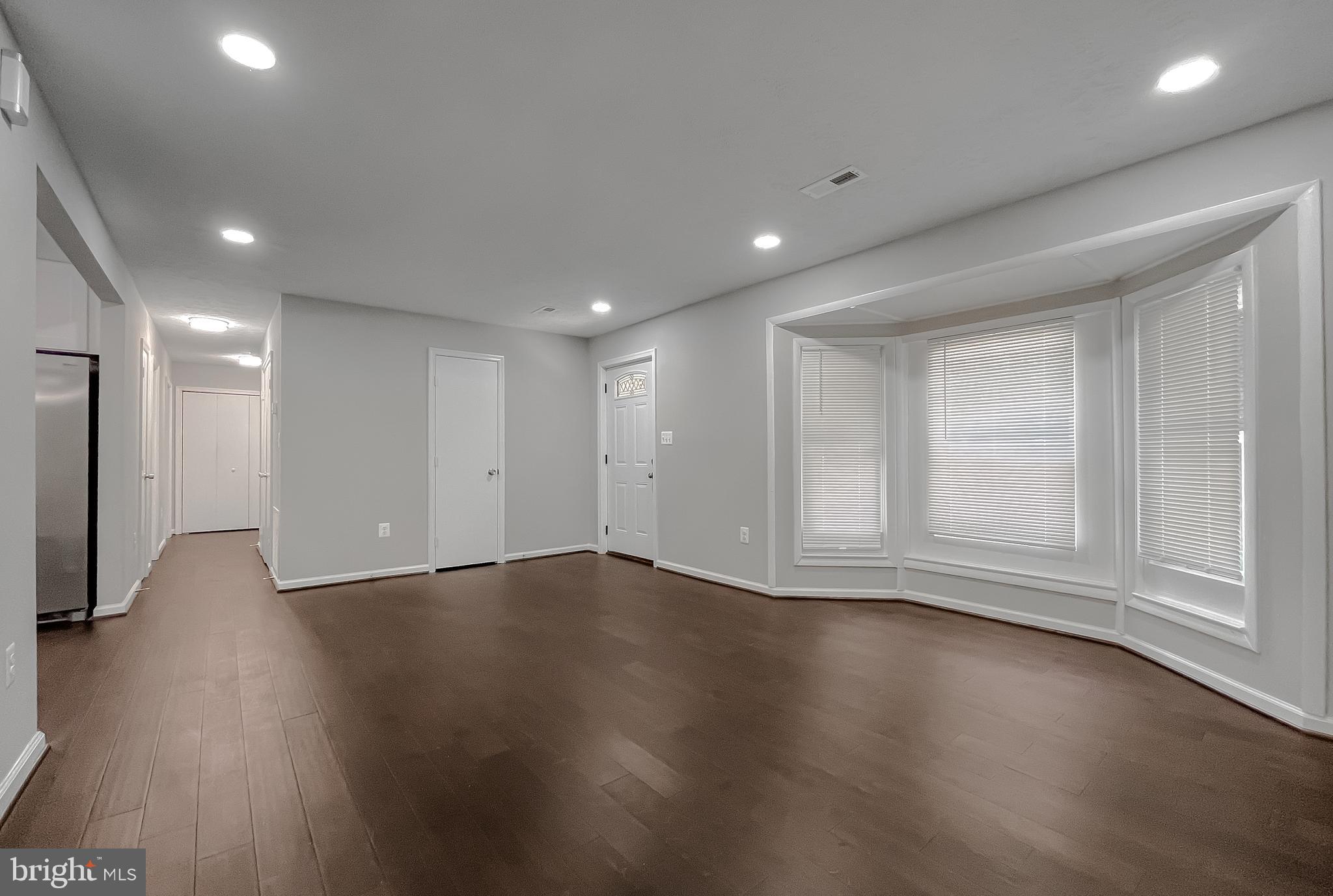 29810 Washington Road Mechanicsville, MD 20659 - Photo 12 of 44 a view of an empty room with wooden floor and a window