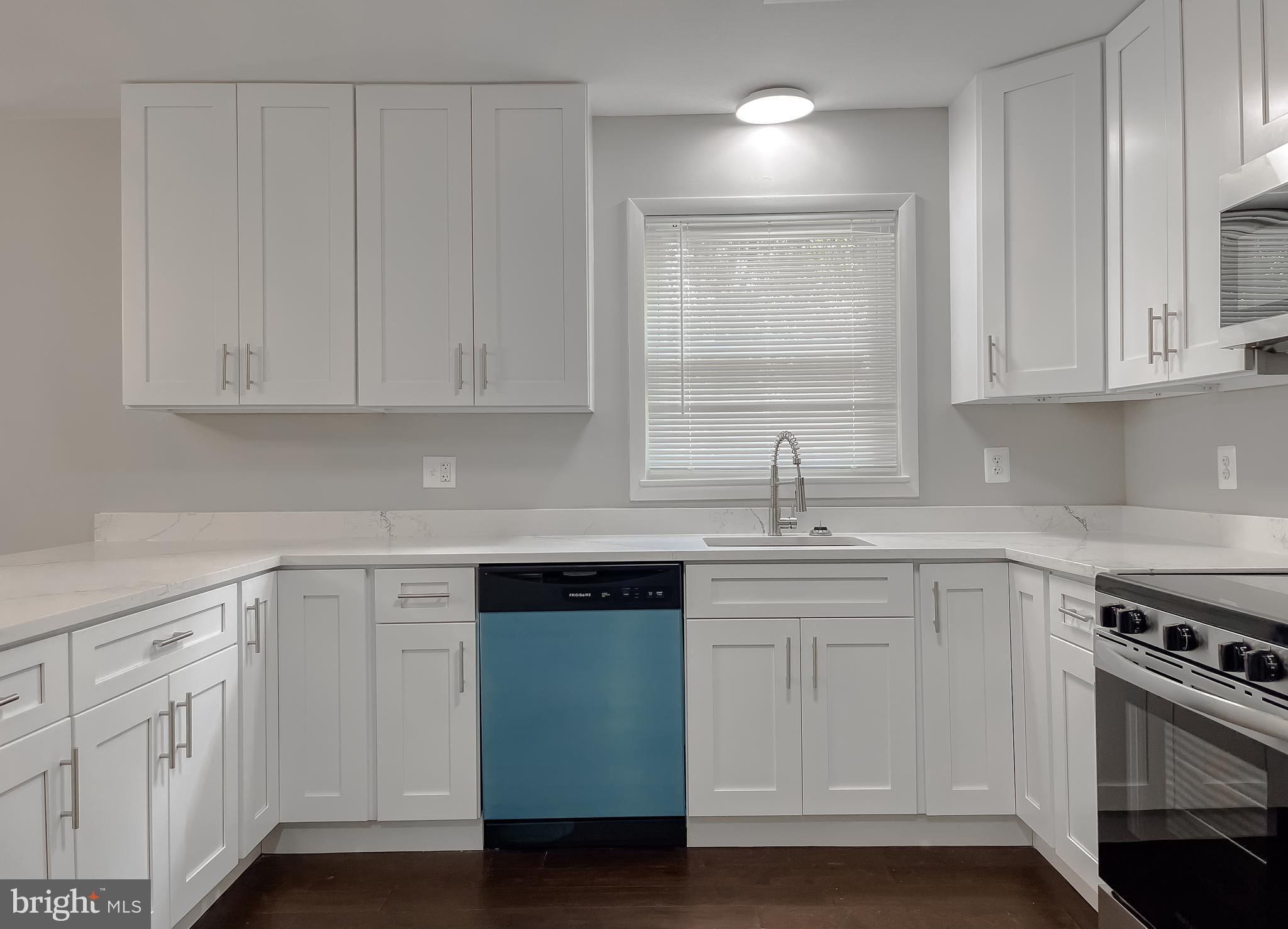 29810 Washington Road Mechanicsville, MD 20659 - Photo 17 of 44 a kitchen with white cabinets and sink