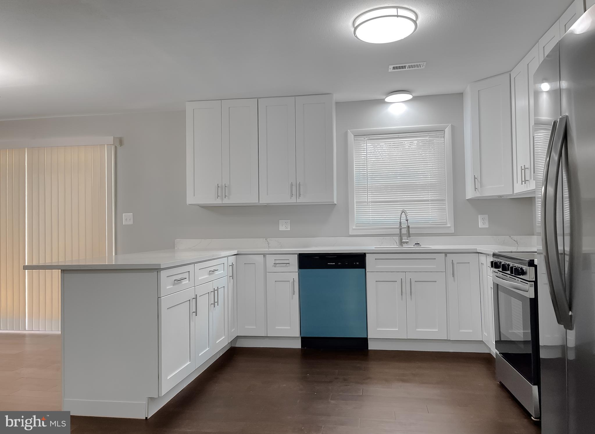 29810 Washington Road Mechanicsville, MD 20659 - Photo 18 of 44 a kitchen with white cabinets stainless steel appliances and sink