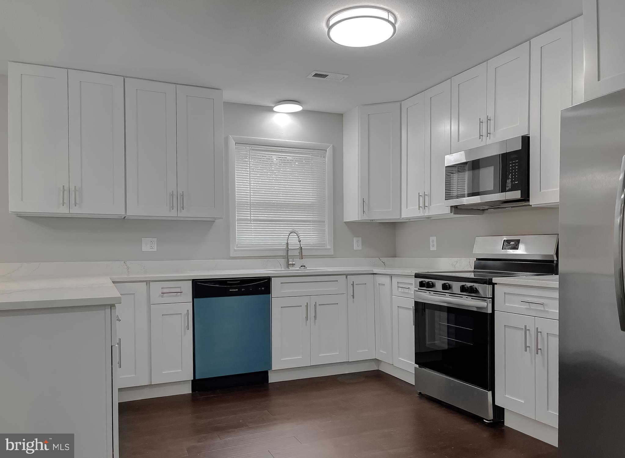 29810 Washington Road Mechanicsville, MD 20659 - Photo 19 of 44 a kitchen with stainless steel appliances granite countertop a stove and a sink