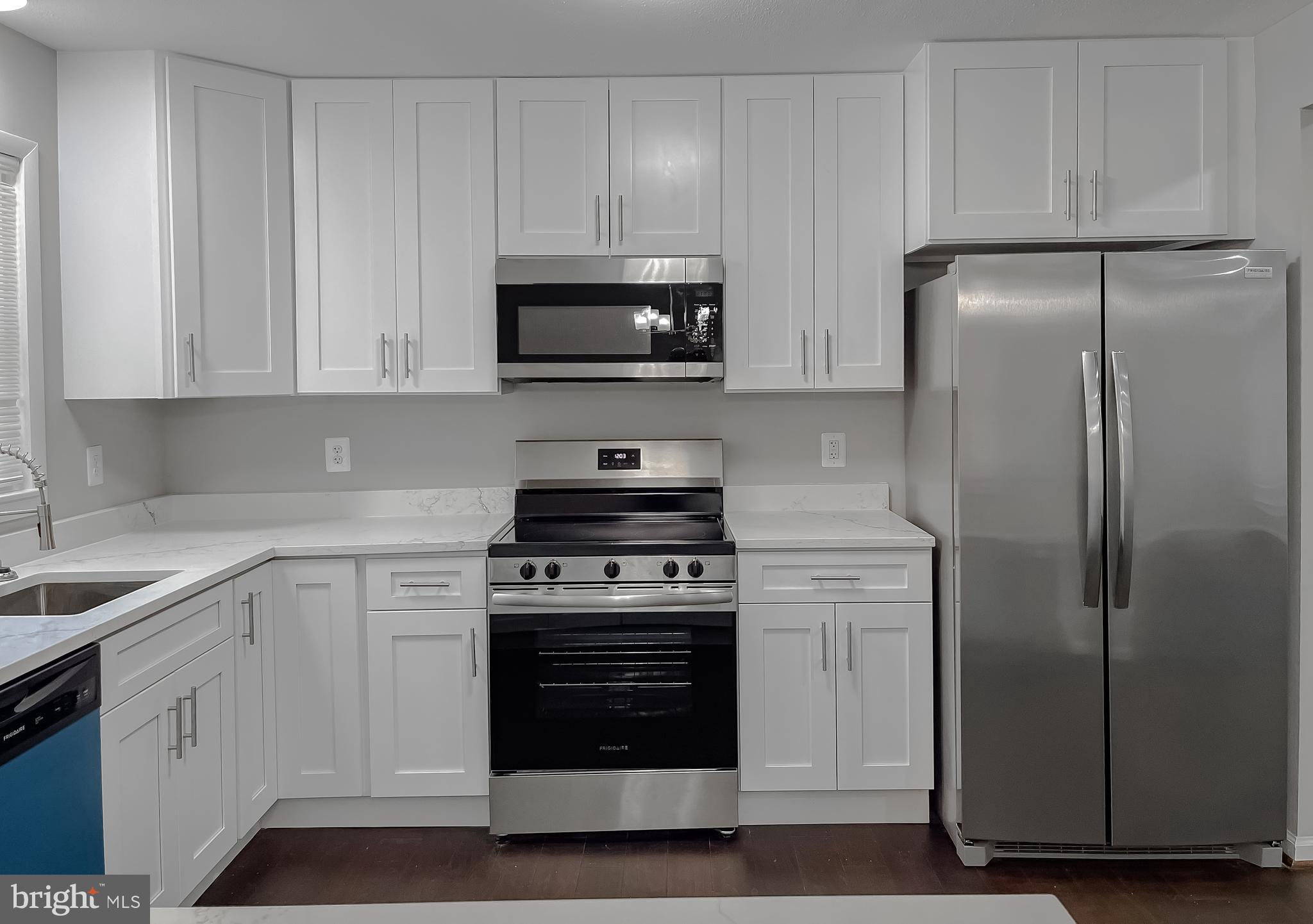 29810 Washington Road Mechanicsville, MD 20659 - Photo 20 of 44 a kitchen with white cabinets and stainless steel appliances