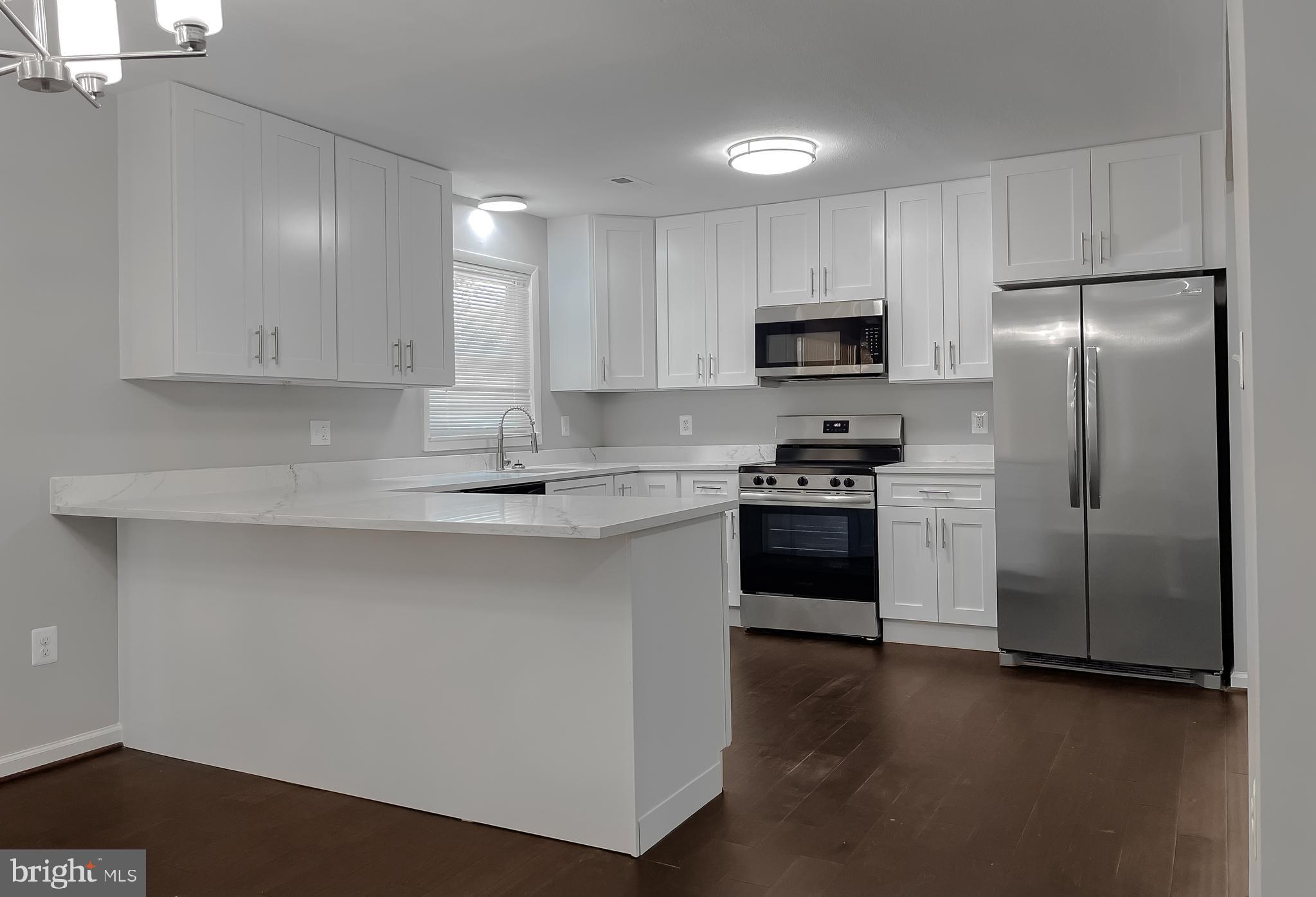 29810 Washington Road Mechanicsville, MD 20659 - Photo 21 of 44 a kitchen with a refrigerator sink and microwave