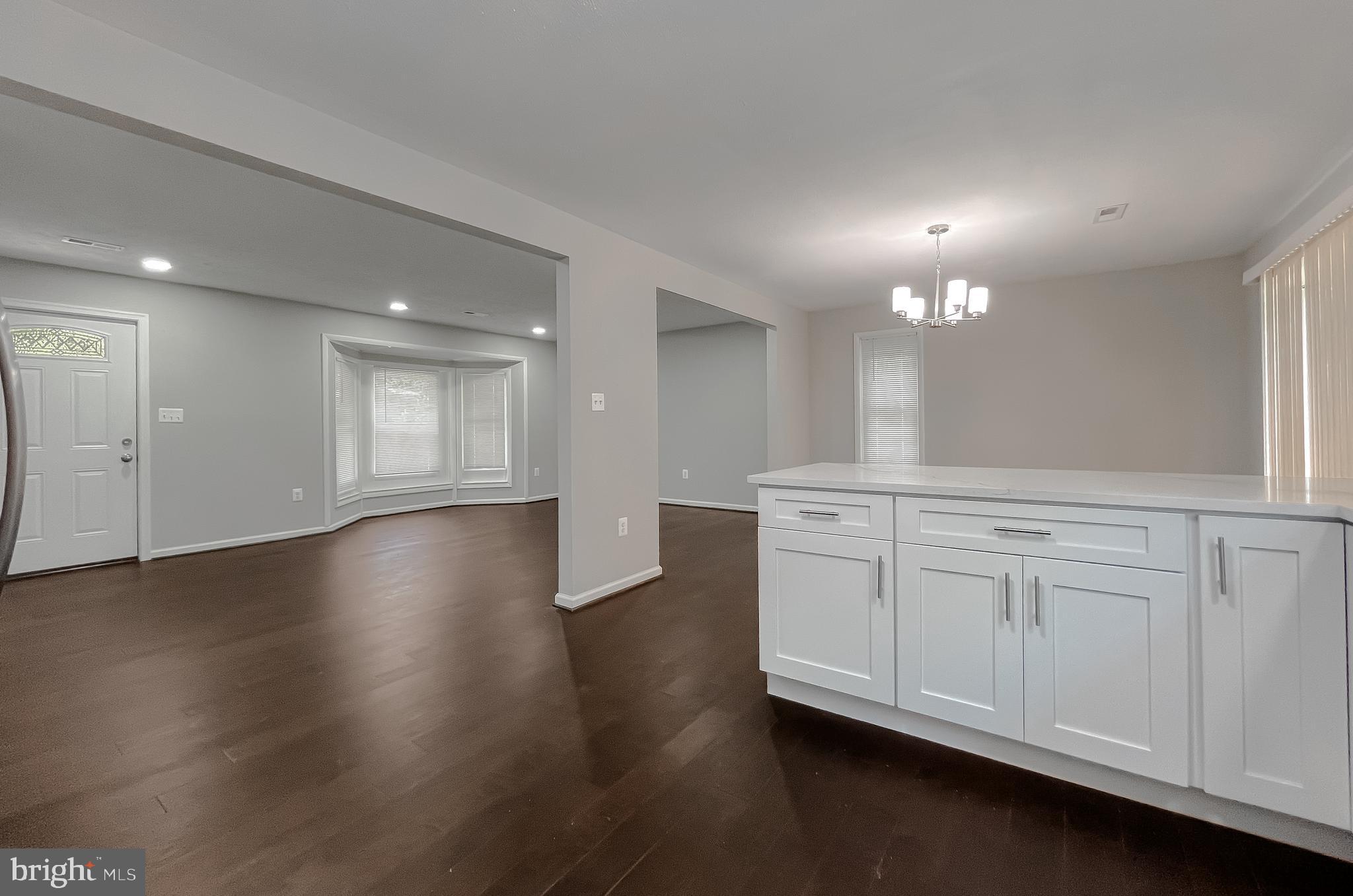 29810 Washington Road Mechanicsville, MD 20659 - Photo 22 of 44 an empty room with wooden floor cabinet and windows