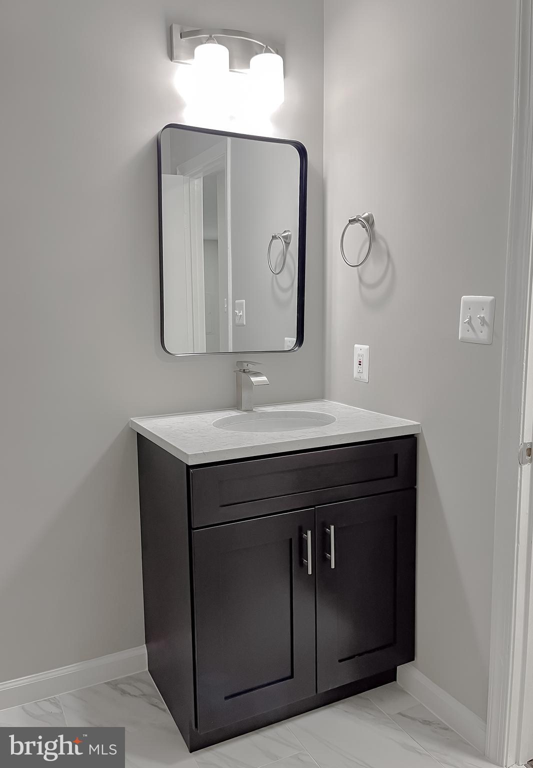 29810 Washington Road Mechanicsville, MD 20659 - Photo 36 of 44 a bathroom with a sink vanity and a mirror