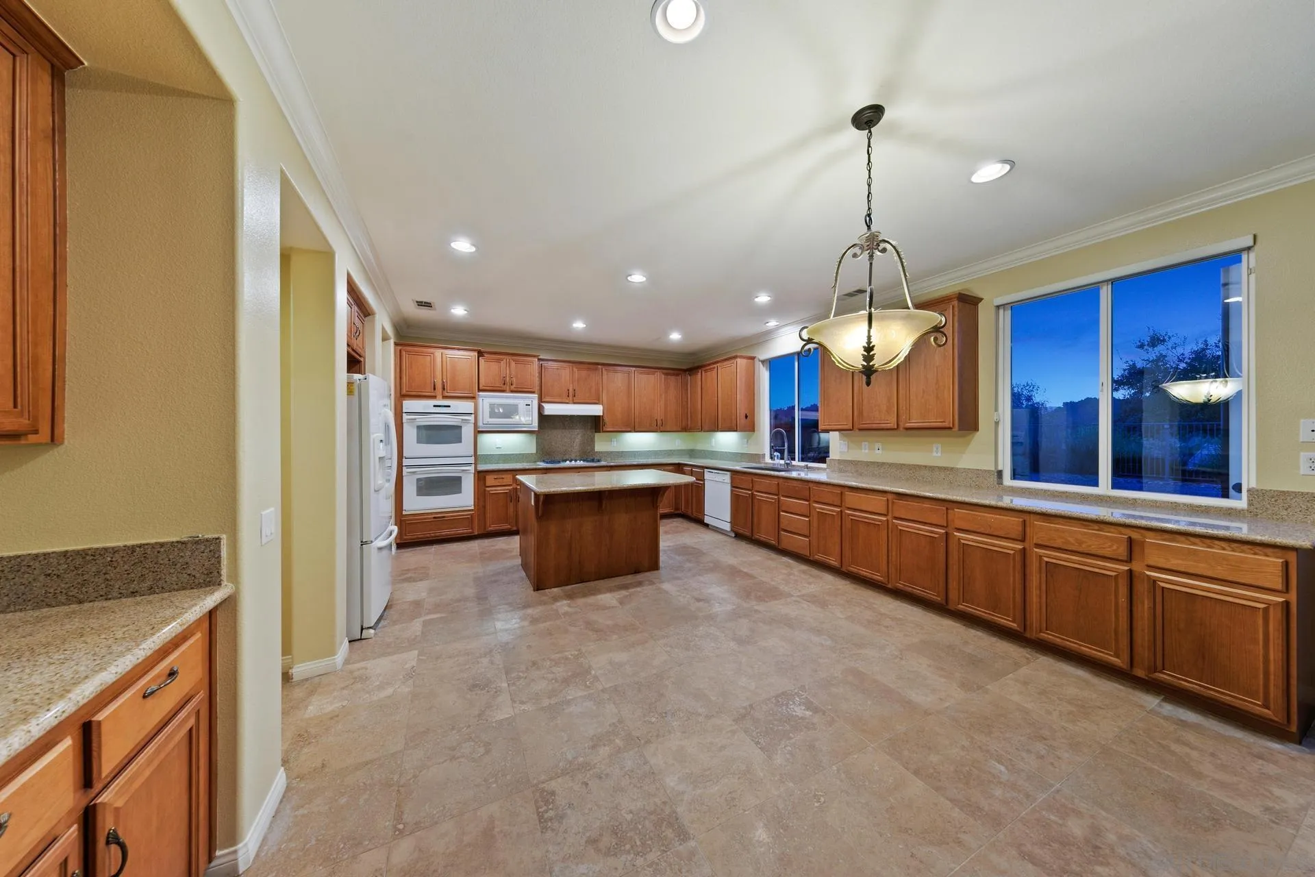 624 Ridgemont Circle Escondido, CA 92027 - Photo 19 of 71 a large kitchen with granite countertop a large counter top a sink stainless steel appliances and cabinets