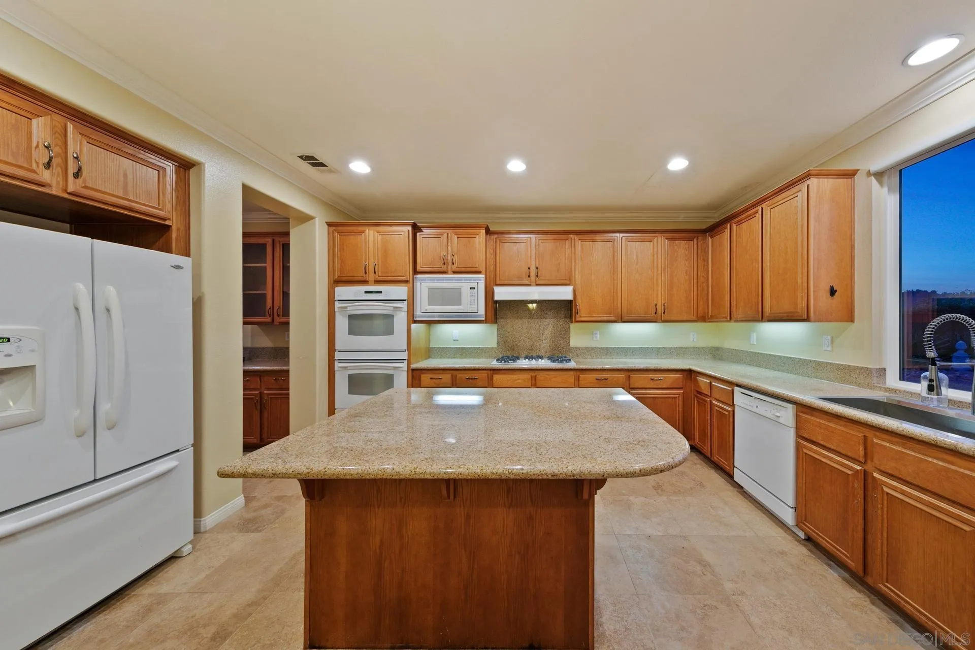 624 Ridgemont Circle Escondido, CA 92027 - Photo 21 of 71 a large kitchen with stainless steel appliances wooden cabinets a center island and a refrigerator