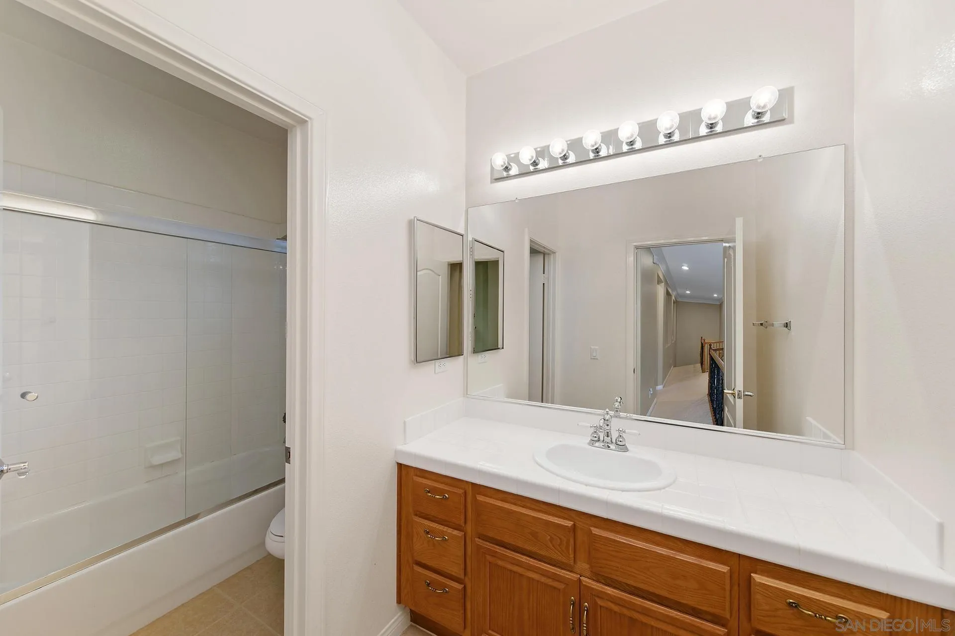 624 Ridgemont Circle Escondido, CA 92027 - Photo 44 of 71 a bathroom with a sink a mirror and a shower