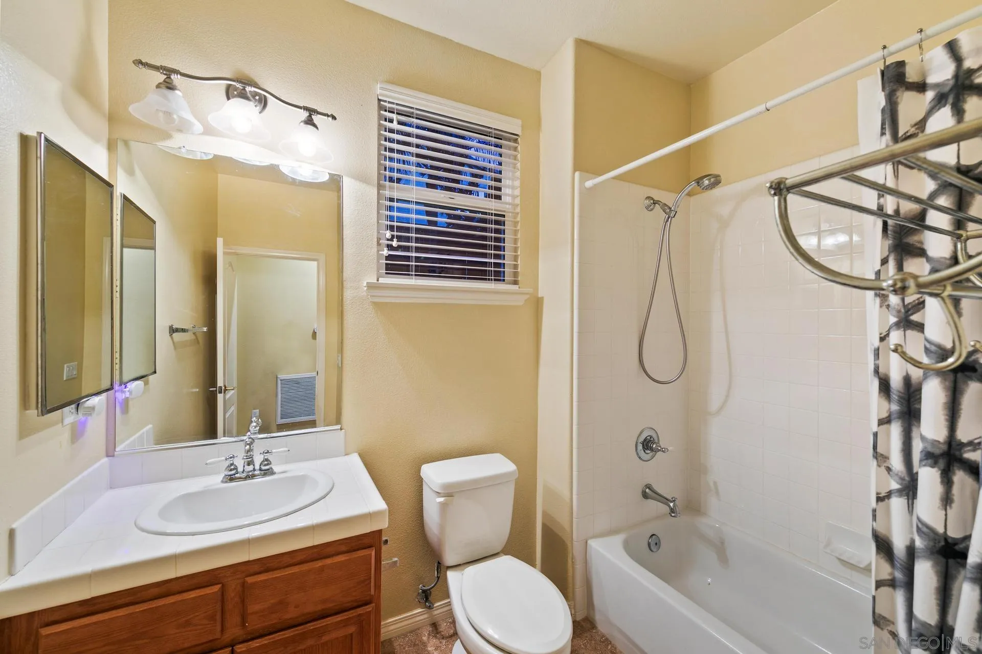 624 Ridgemont Circle Escondido, CA 92027 - Photo 51 of 71 a bathroom with a sink a toilet a mirror and shower