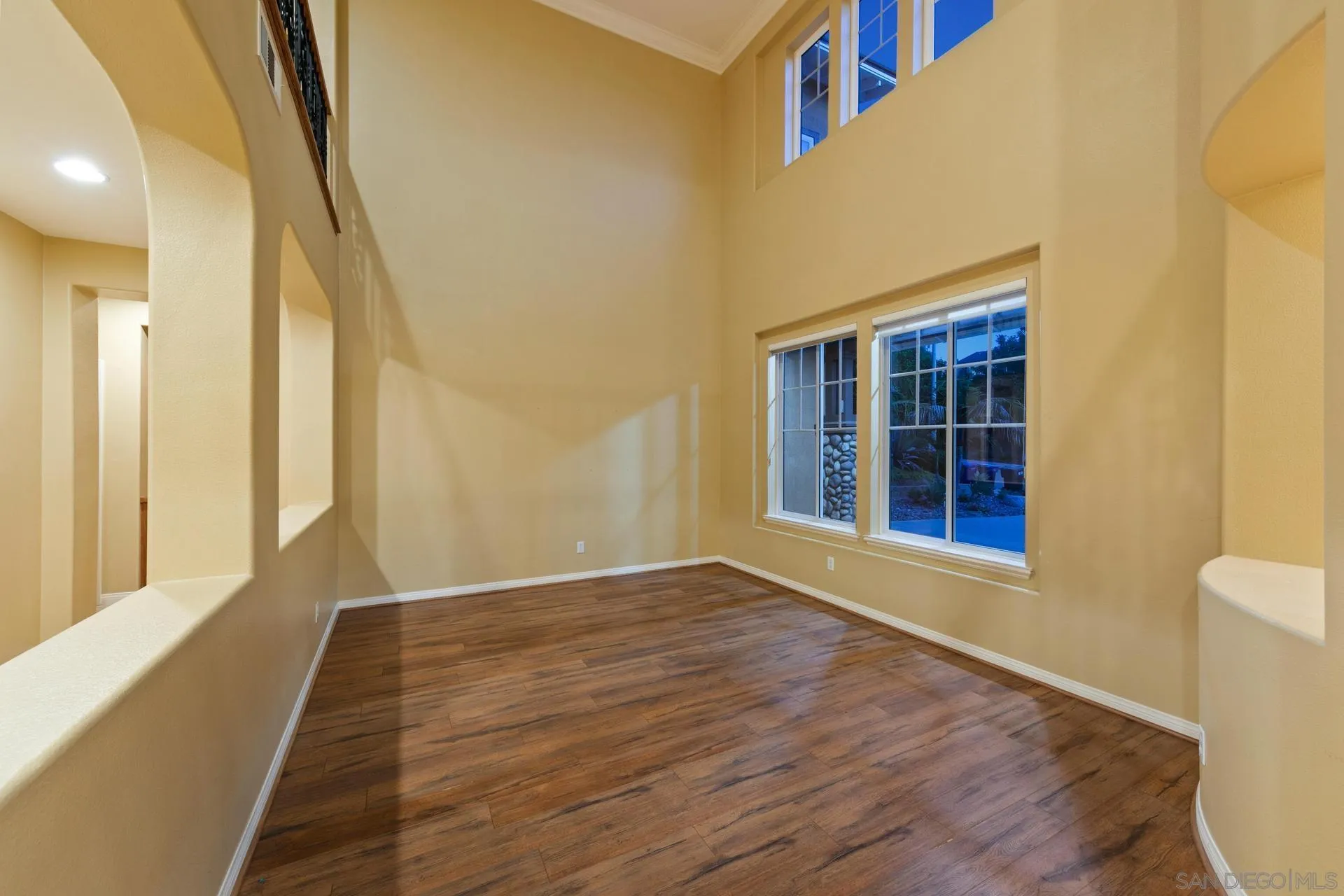 624 Ridgemont Circle Escondido, CA 92027 - Photo 10 of 71 a view of an empty room with wooden floor and a window