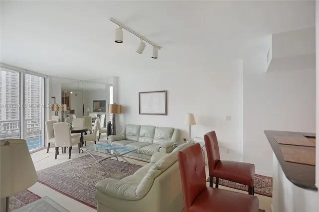 a living room with furniture a rug and a flat screen tv