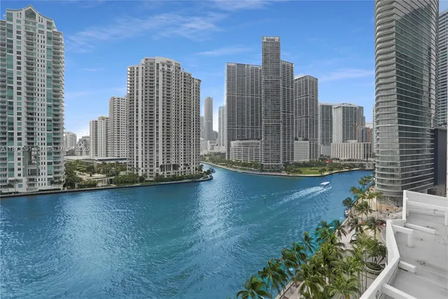 a balcony with chairs and potted plants
