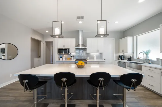 a view of a patio with a dining table and chairs with wooden floor