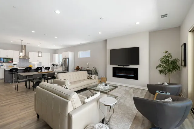 an aerial view of residential houses with outdoor space and swimming pool